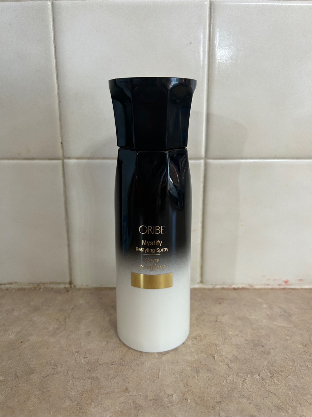 Oribe Mystify Restyling Spray — Black to White Ombre Bottle with Gold Accent